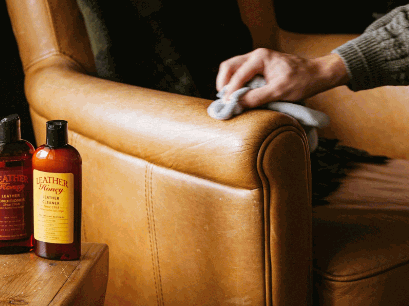 Applying leathe conditioner to leather sofa